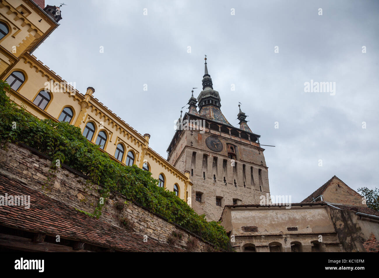 Sighisoara Clock Tower (Turnul cu Ceas) during a cloudy fall afternoon. It is the main entrance of Sighisoara castle, in Romania, birthplace of Vlad T Stock Photo