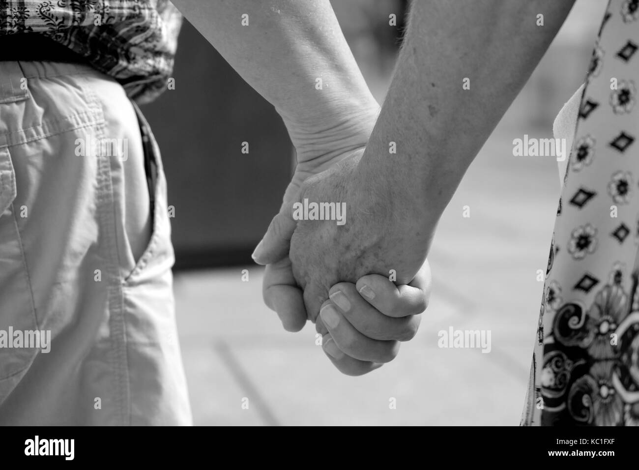 18th september 2017, Mature couple on vacation holding hands. Stock Photo