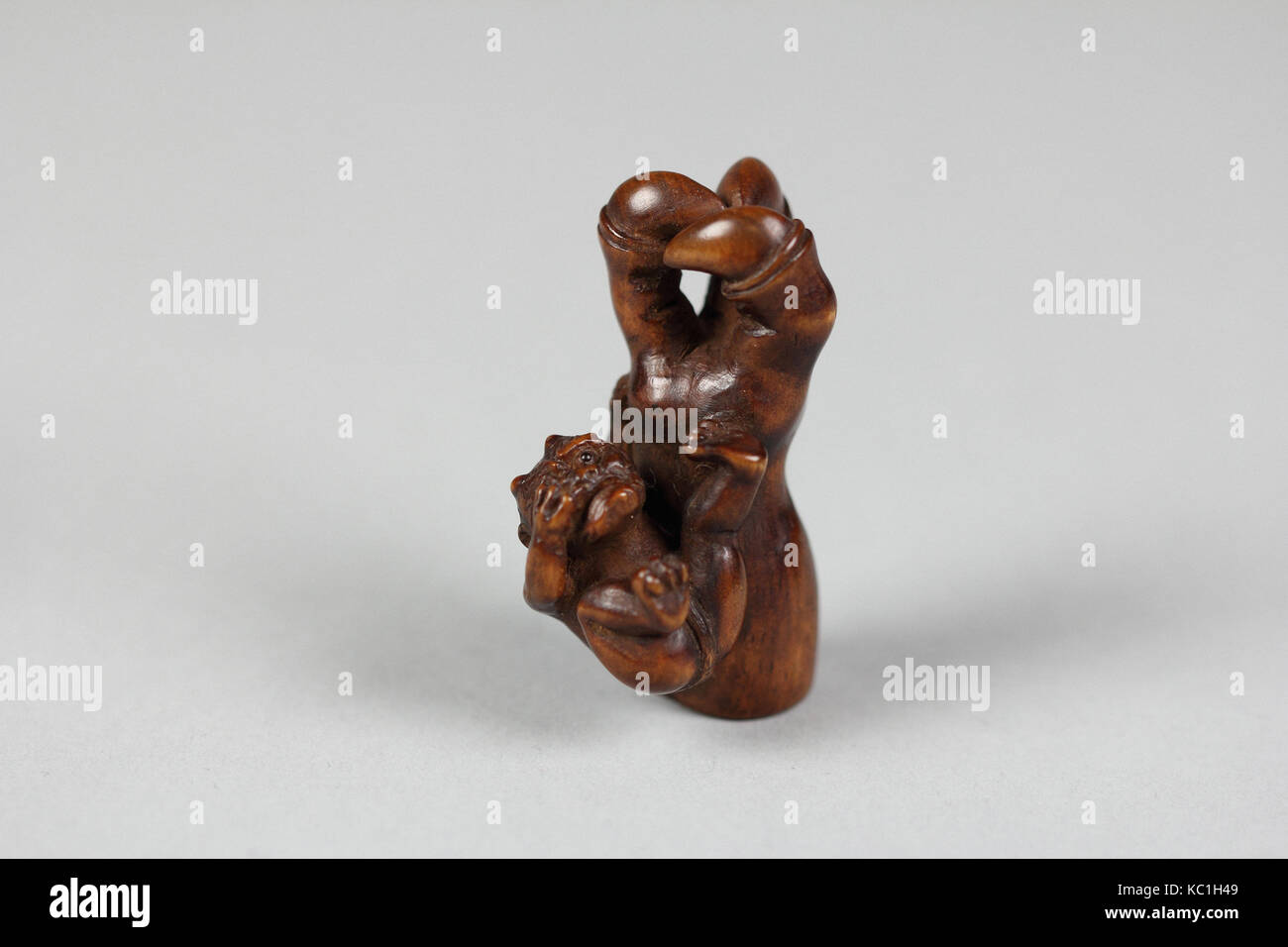 Netsuke of Ōni (Demon) Weeping Beside Giant Arm of Demon, 19th century Stock Photo