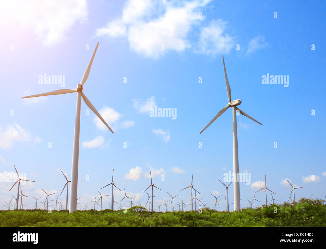 Wind turbines on blue sky background Stock Photo - Alamy