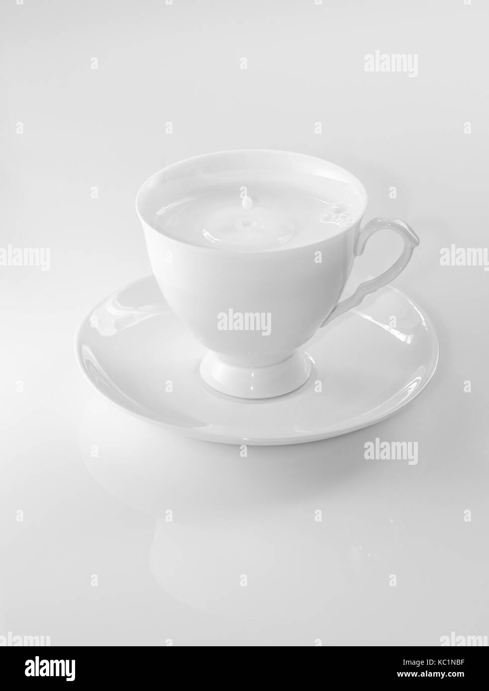 white tea set with pouring milk Stock Photo Alamy