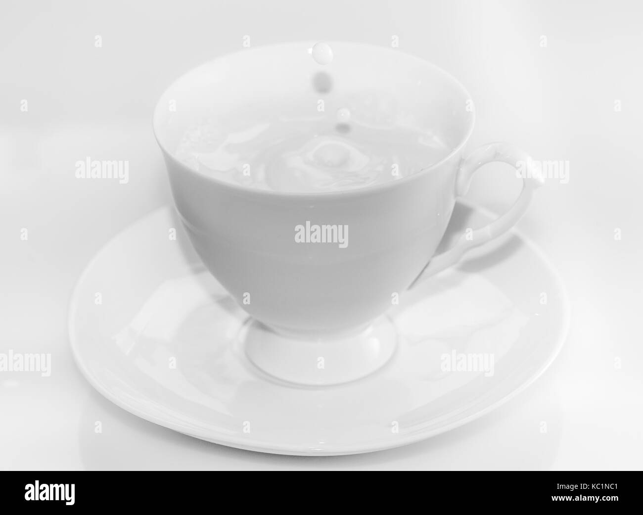 white tea set with pouring milk Stock Photo Alamy