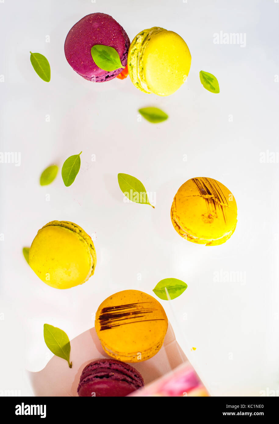 Flying macarons with green leaves Stock Photo