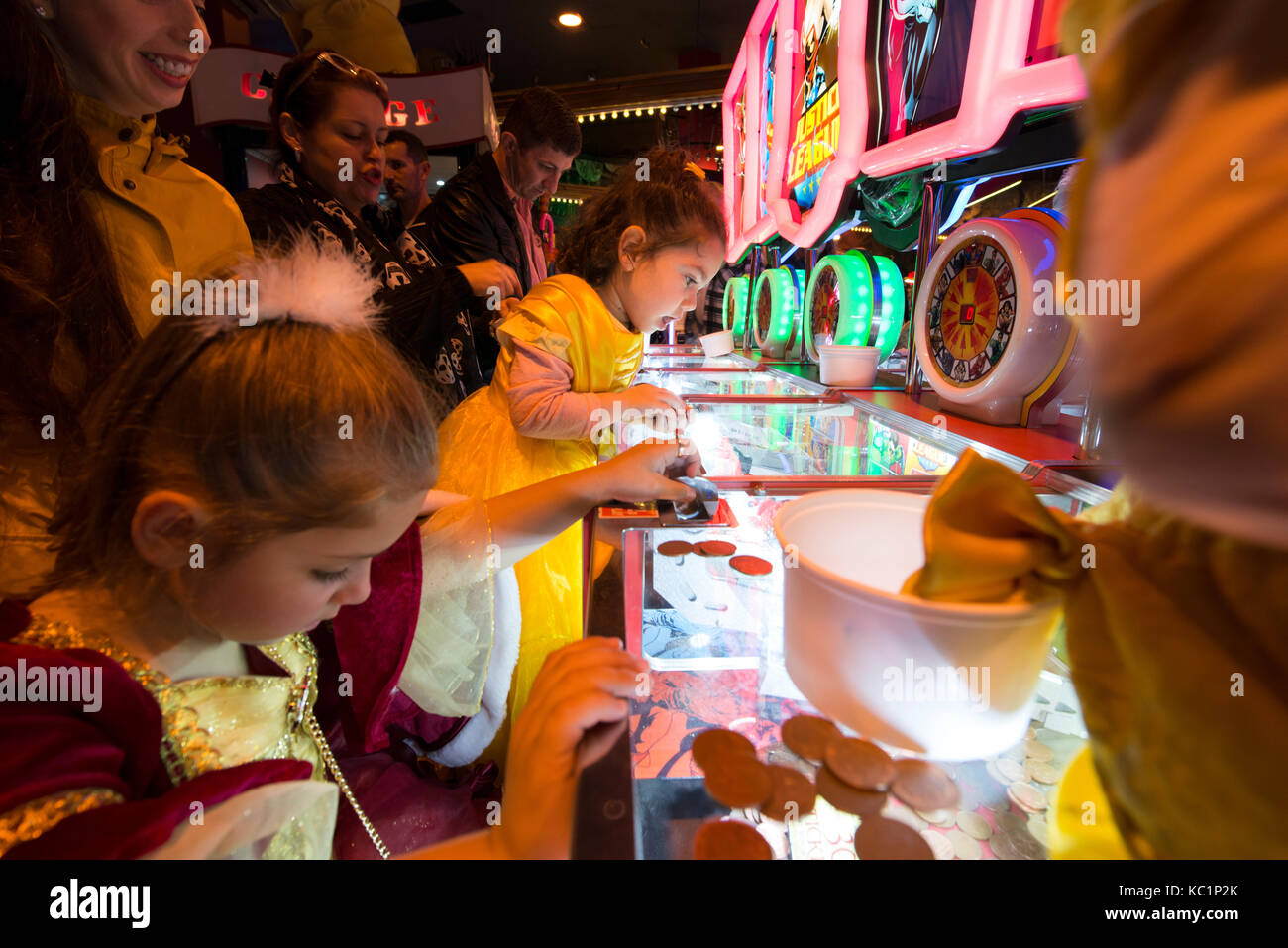 Young children playing penny arcade gambling machines in Blackpool Coral Island. Credit, LEE