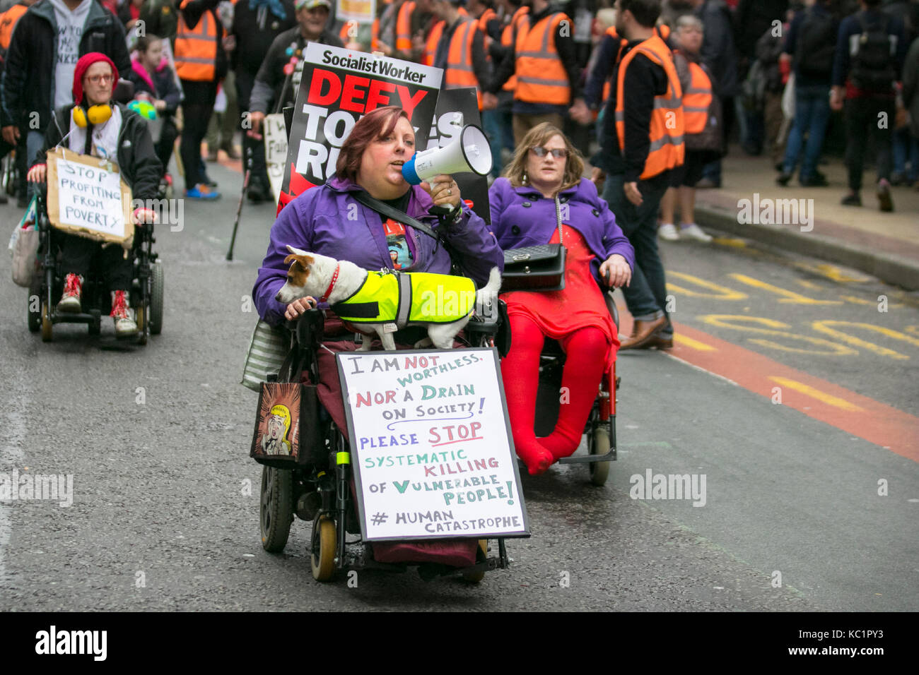 Disabled protestors in powered wheelchairs in Manchester, UK. October, 2017. Thousands of demonstrators bring the streets of Manchester to a standstill as protestors take part in a massive 'Tories Out' protest to end Austerity measures.  Anti-Brexit campaigners and activists protesting the government’s austerity policies are holding rallies to coincide with the start of the Conservative Party conference being held in the city centre. Stock Photo
