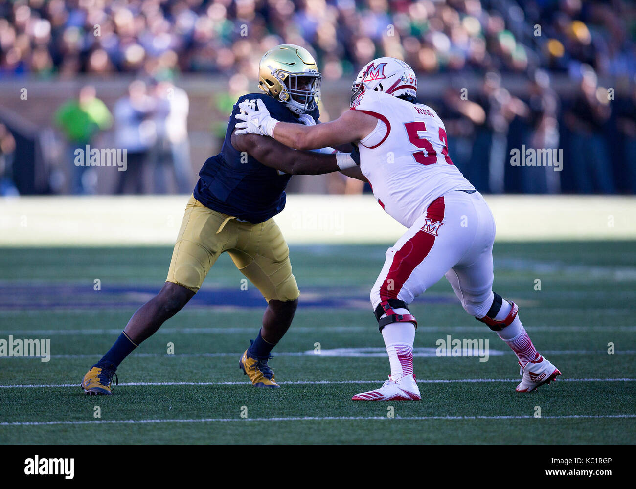 South Bend, Indiana, USA. 30th Sep, 2017. Notre Dame defensive lineman Jay Hayes (93) and Miami-Ohio offensive line Jordan Rigg (52) battle at the line of scrimmage during NCAA football game action between the Miami-Ohio RedHawks and the Notre Dame Fighting Irish at Notre Dame Stadium in South Bend, Indiana. Notre Dame defeated Miami-Ohio 52-17. John Mersits/CSM/Alamy Live News Stock Photo