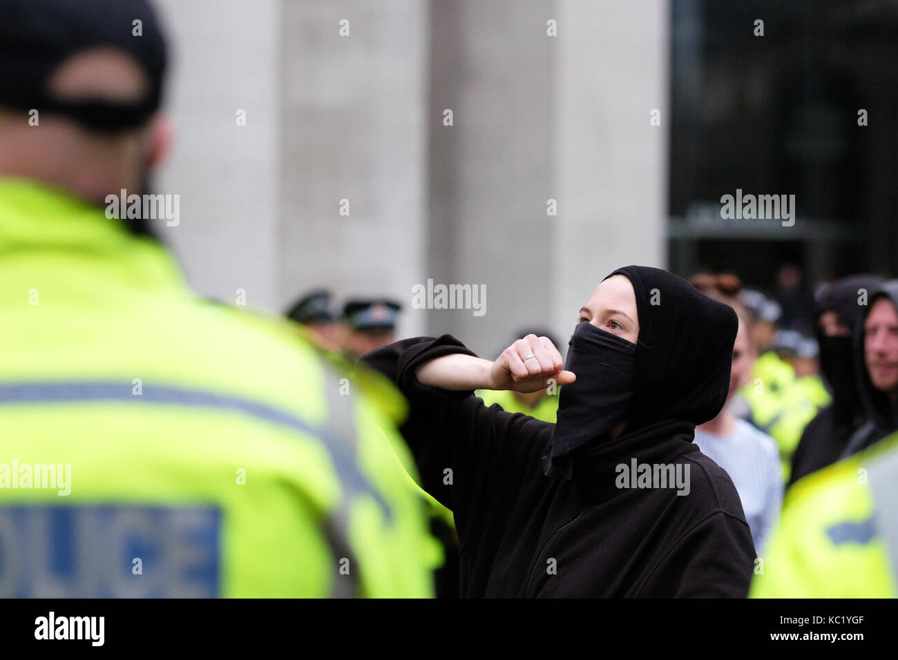 St Peters Square, Manchester, UK - Sunday 1st October 2017 - A protester surrounded and kettled by a ring of Police officers outside the Conservative Party Conference. Photo Steven May / Alamy Live News Stock Photo