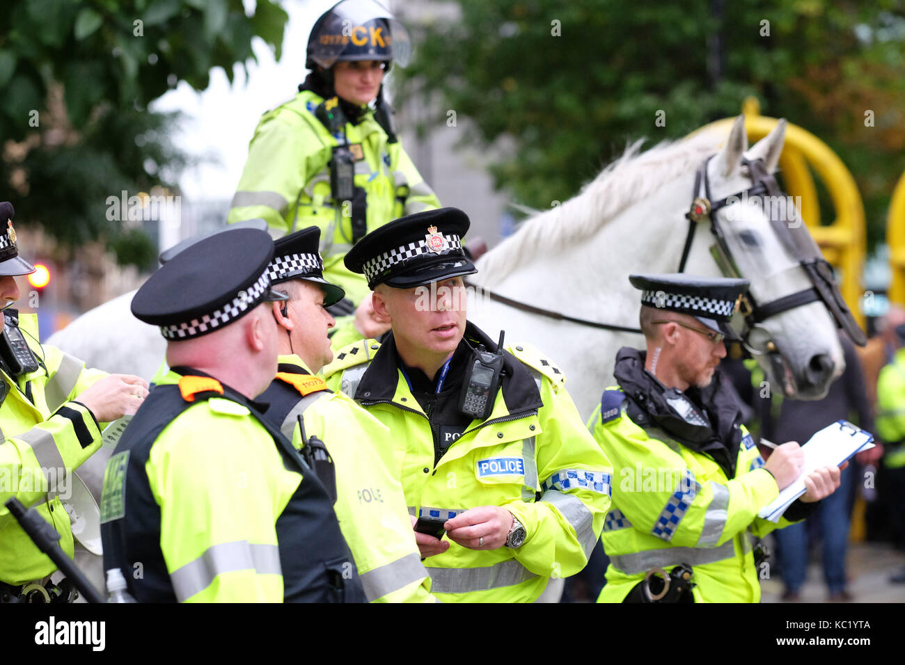 St Peters Square, Manchester, UK - Sunday 1st October 2017 - Senior Police officers discuss tactics whilst trying to contain a group of protesters outside the Conservative Party Conference. Photo Steven May / Alamy Live News Stock Photo