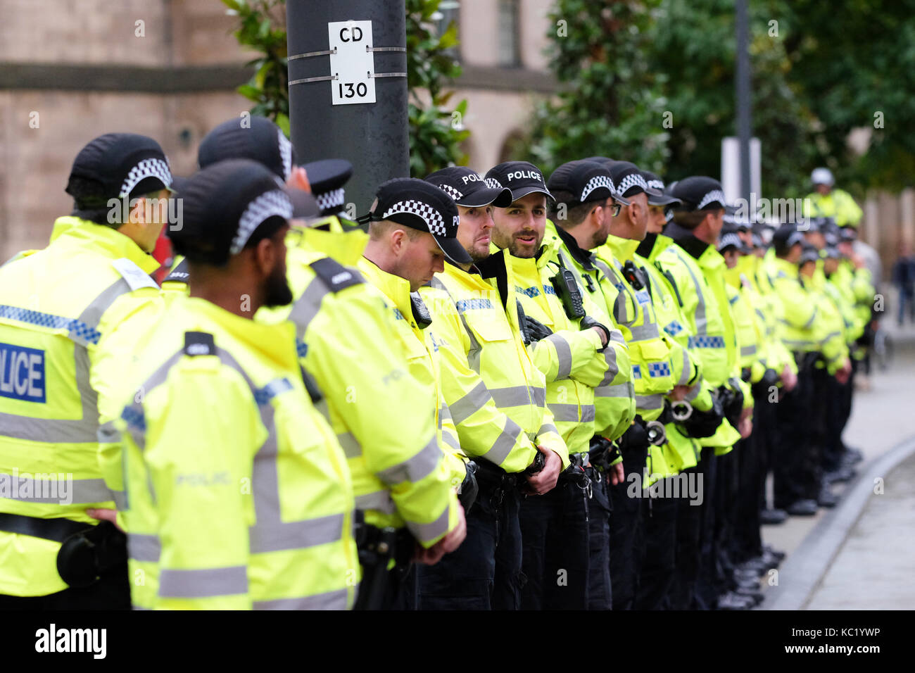St Peters Square, Manchester, UK - Sunday 1st October 2017 - A long line of Police officers deployed around the outside the Conservative Party Conference. Photo Steven May / Alamy Live News Stock Photo