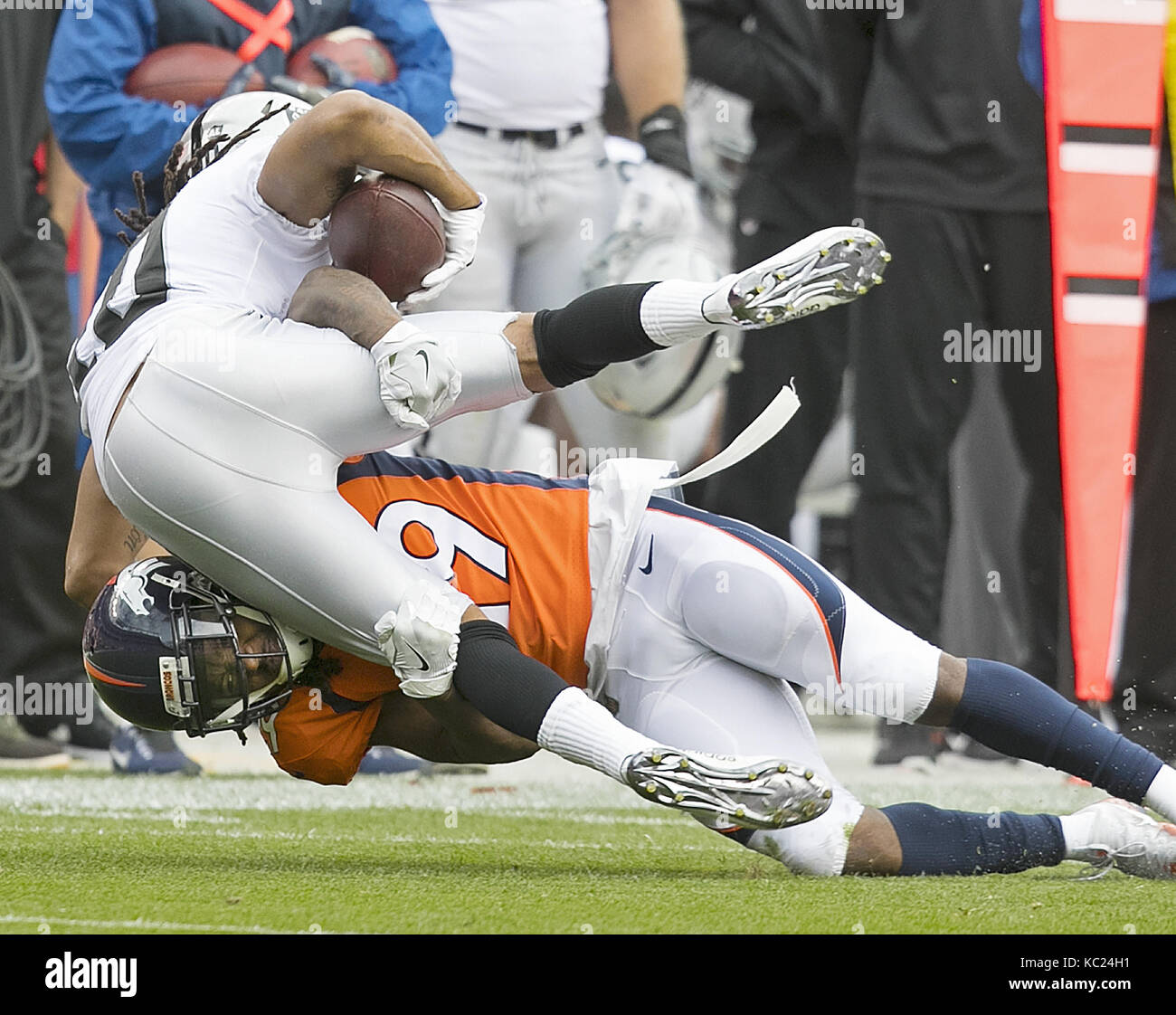 Denver, Colorado, USA. 1st Oct, 2017. Broncos CB BRADLEY ROBY, bottom, makes a tackle on Raiders SETH ROBERTS, left, during the 1st. Half at Sports Authority Field at Mile High Sunday afternoon. Broncos beat the Raiders 16-10. Credit: Hector Acevedo/ZUMA Wire/Alamy Live News Stock Photo