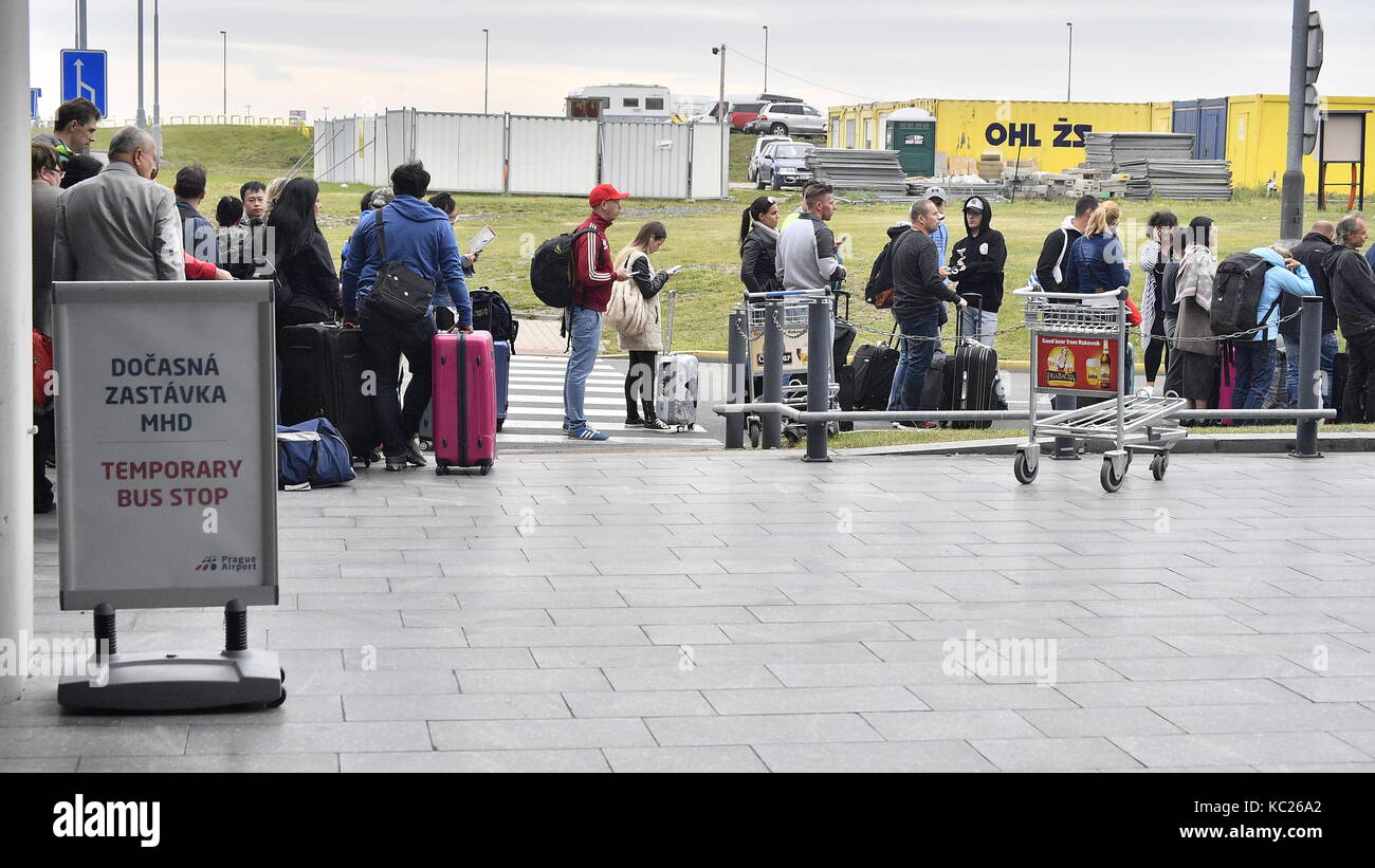 Association of Czech Taxi Drivers organized a go-slow protest against Uber services in vicinity of Ruzyne airport in Prague, Czech Republic, on October 2, 2017. On the photo is seen a queue of passengers at the Vaclav Havel Airport Prague. Passengers wait for a bus of the Prague public transport. There were no regular bus stops in front of the airport due to the protest, the Prague public transport company set up a temporary stop at Terminal 2. (CTK Photo/Michal Dolezal) Stock Photo