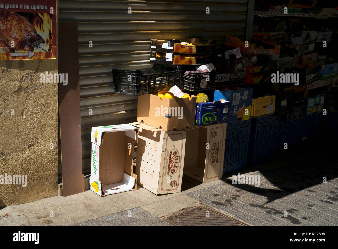 Fruit and vegetables stacked up in boxes and pallets in a side street of Lloret de Mar, Spain Stock Photo