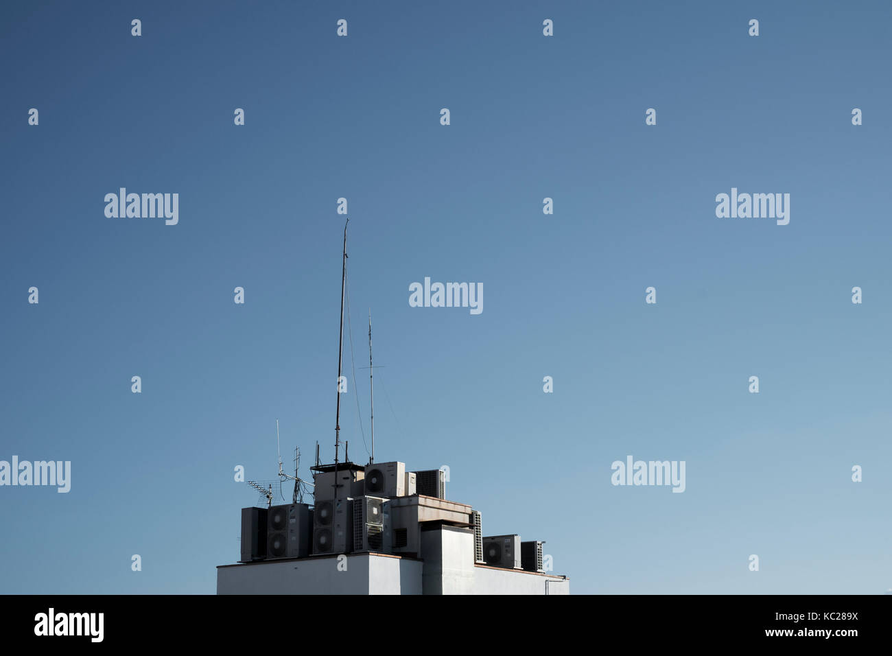 Air conditioning units and aerials above a residential property in Lloret de Mar Stock Photo