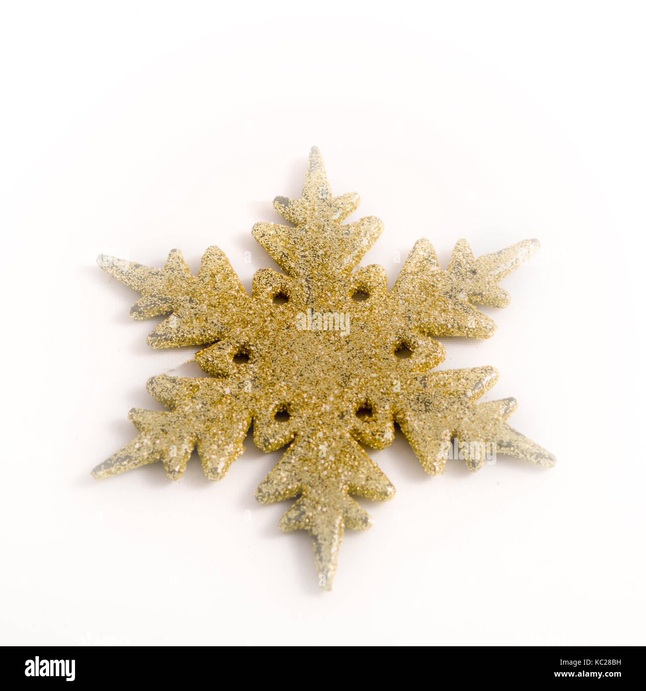 Gold colored christmas star on white background Stock Photo - Alamy