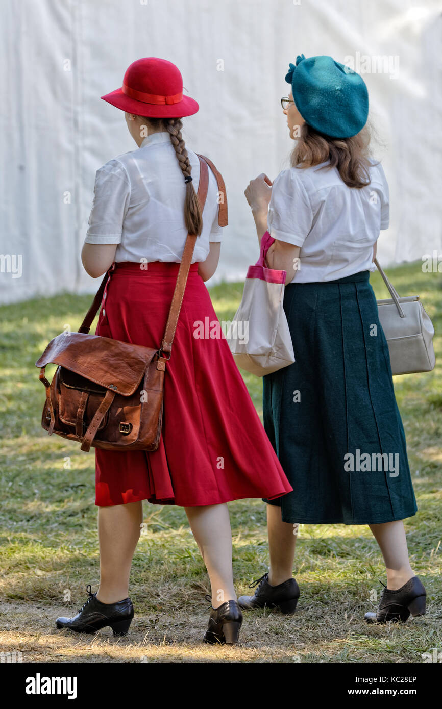 Two young women strolling in modern retro vintage style outfits Stock Photo Alamy