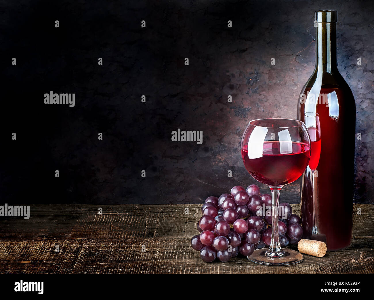 Glass of red wine with grapes and bottle Stock Photo