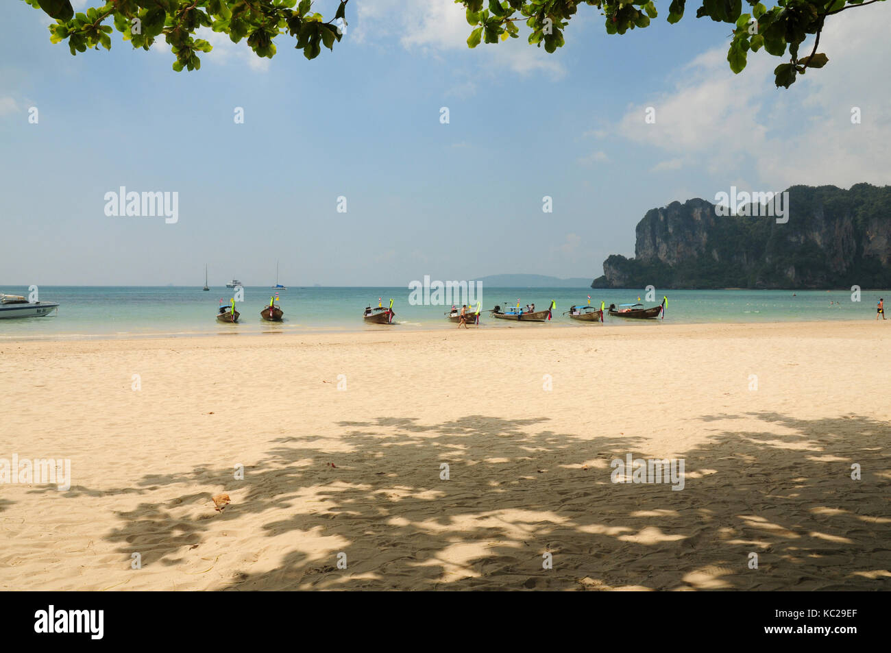 Long tail boats lined up along the shore on Krabi island, Thailand Stock Photo