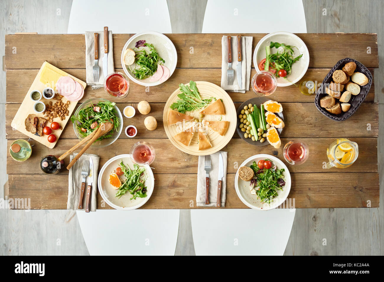 Above view of dinner table with delicious food set for four in cafe or