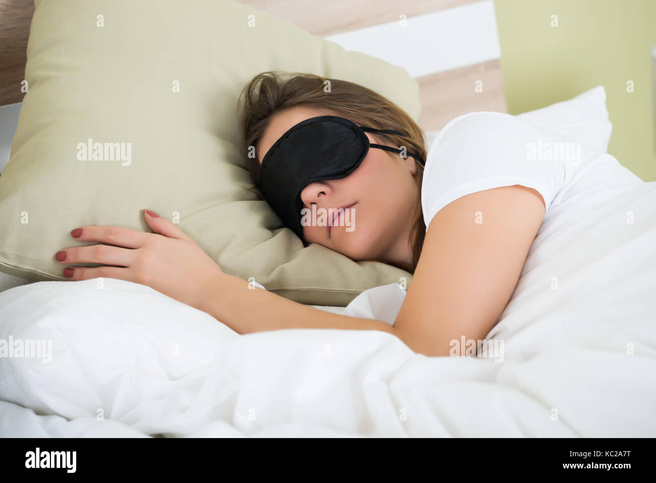 Young Woman Wearing Eye Mask While Sleeping On Bed Stock Photo Alamy