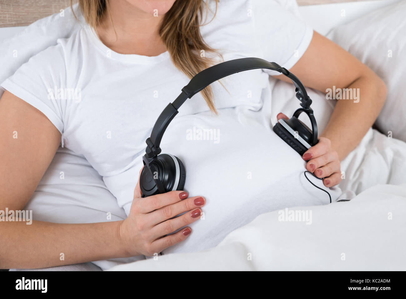 Pregnant woman with headphones on belly, Stock Photo, Picture And Royalty  Free Image. Pic. WR0252878