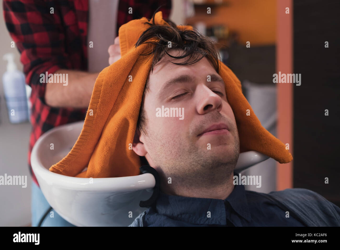 Young Mcaucasian Man Is Relaxing In Barbershop During Haircut