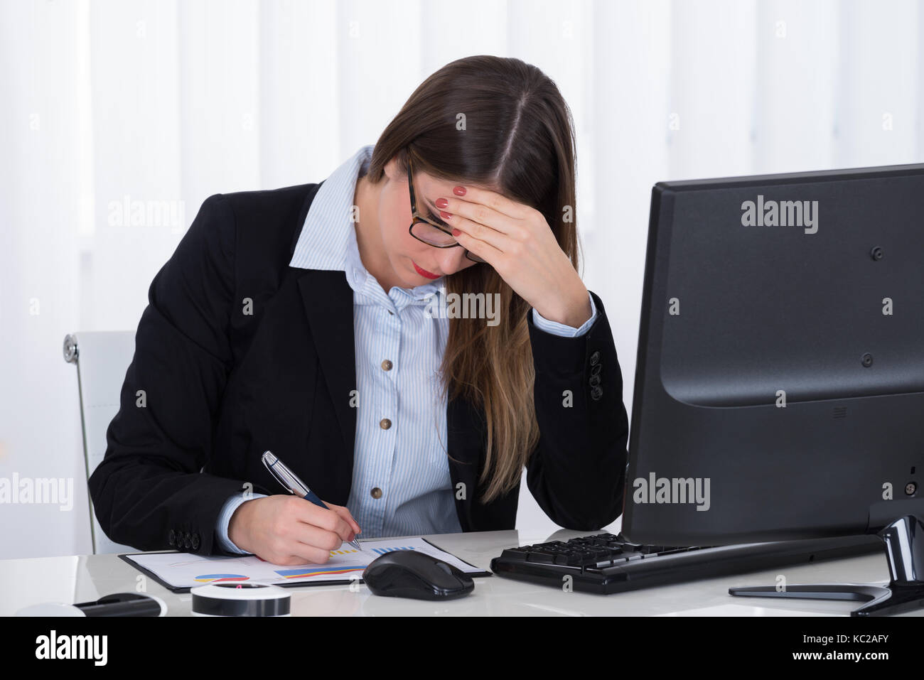 Stressed Young Businesswoman Sitting In Office With Financial Report ...