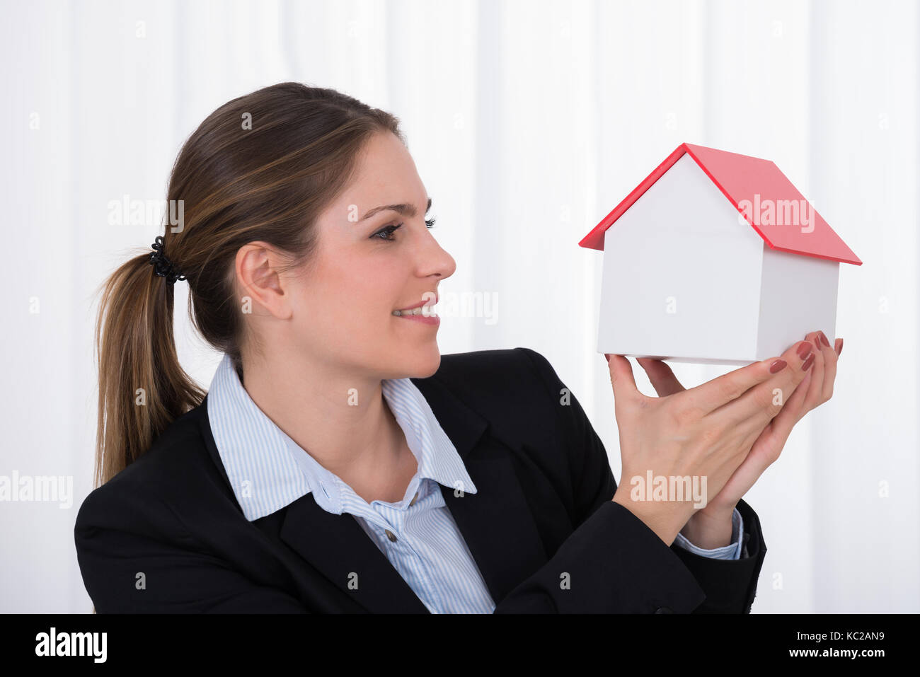 Portrait Of Happy Businesswoman Holding House Model Stock Photo - Alamy