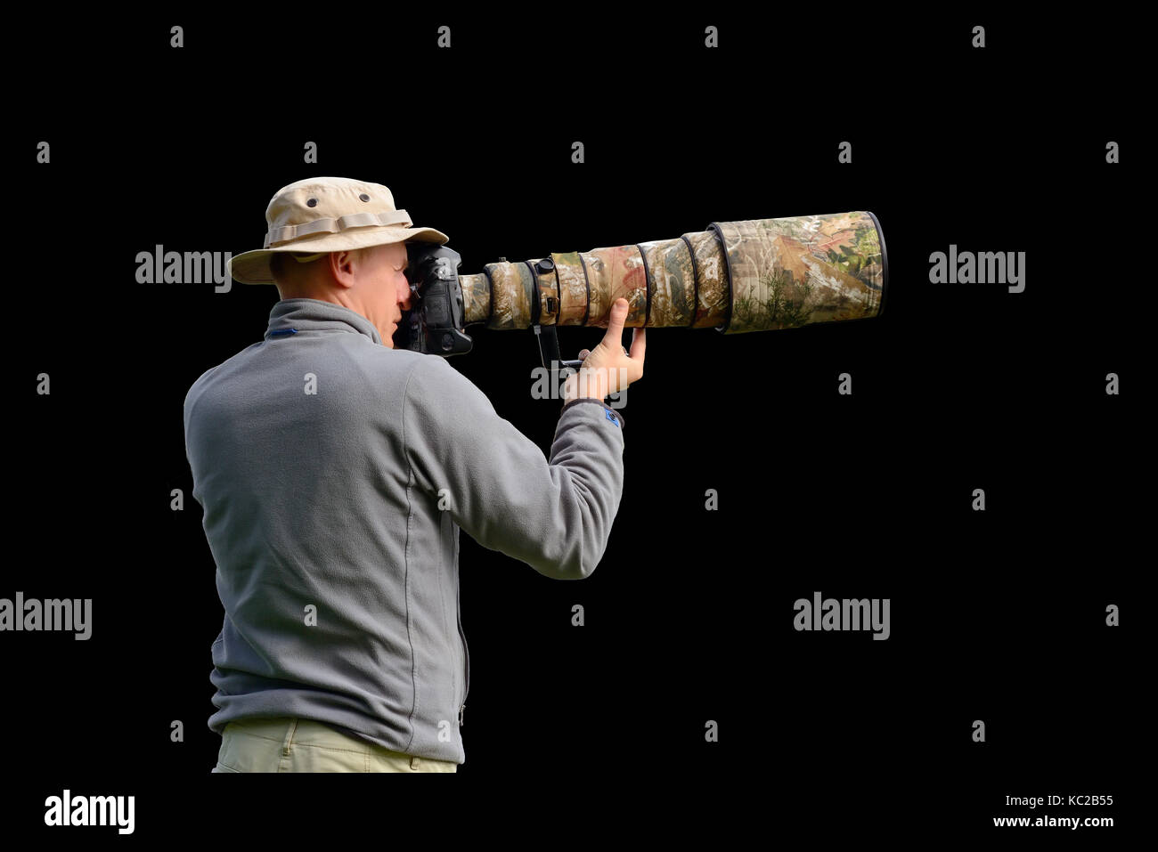 Professional wildlife photographer isolated on black background Stock Photo