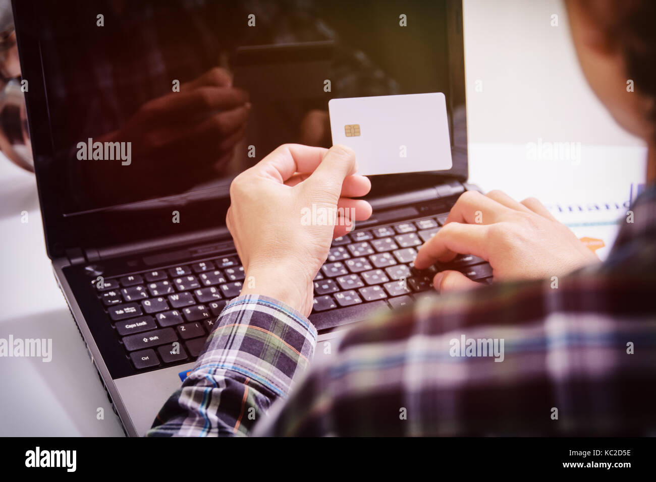 male hands holding credit card typing numbers on computer keyboard :online shopping concept Stock Photo
