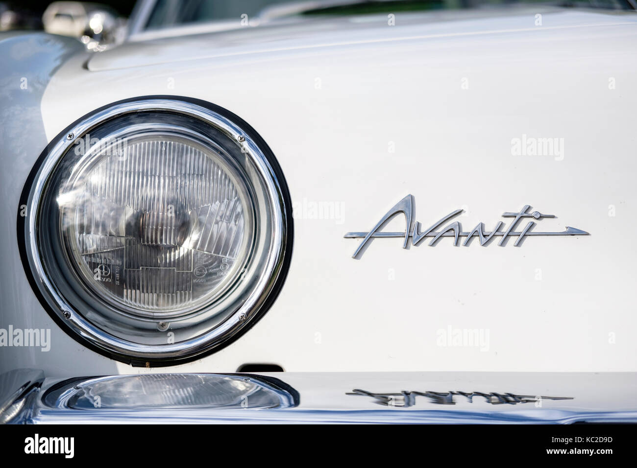 Front view of white 1963 Studebaker Avanti S, close-up of headlight and logo. Stock Photo