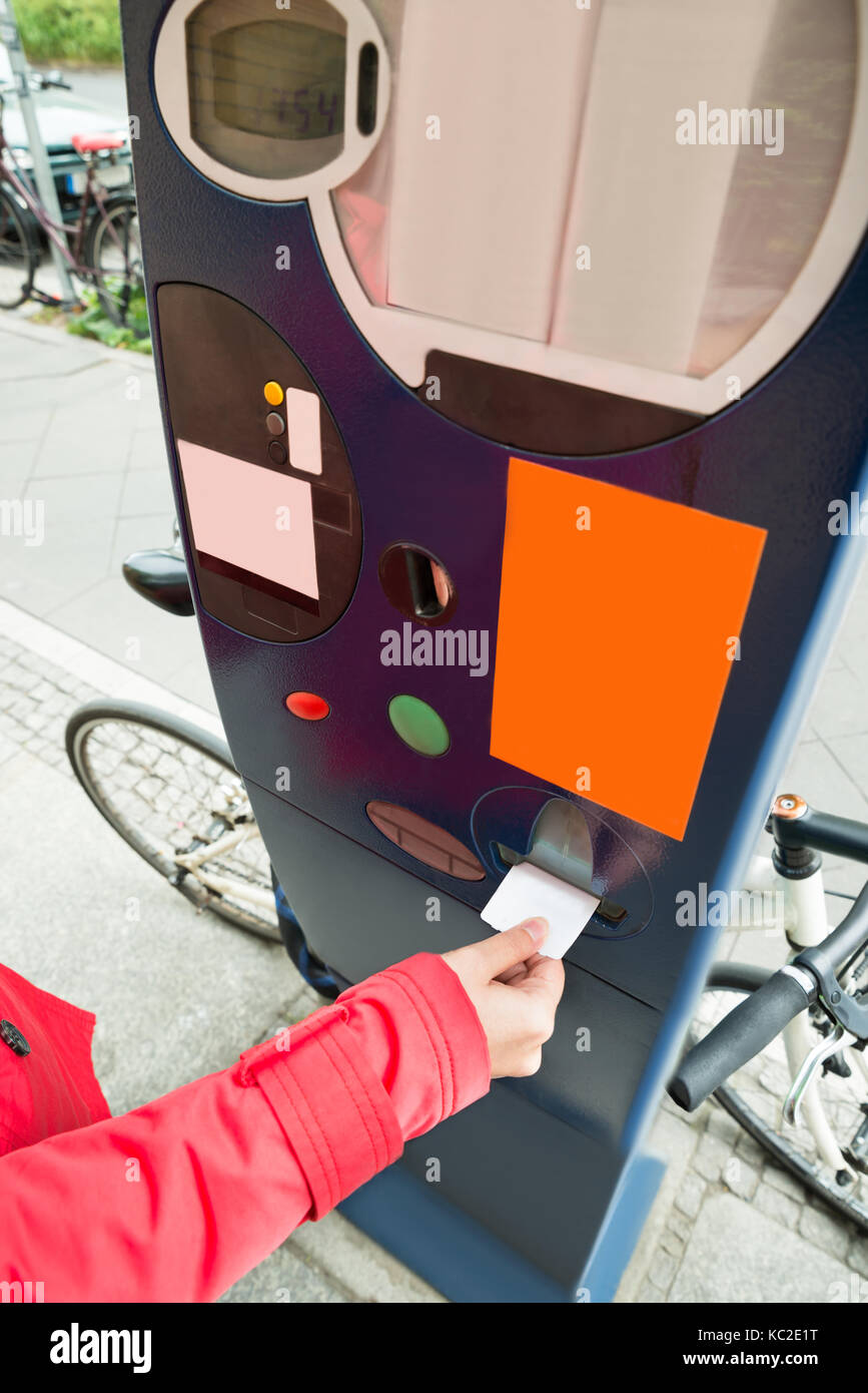 Close-up Of Person Hands Paying For Parking In Parking Meter Stock Photo