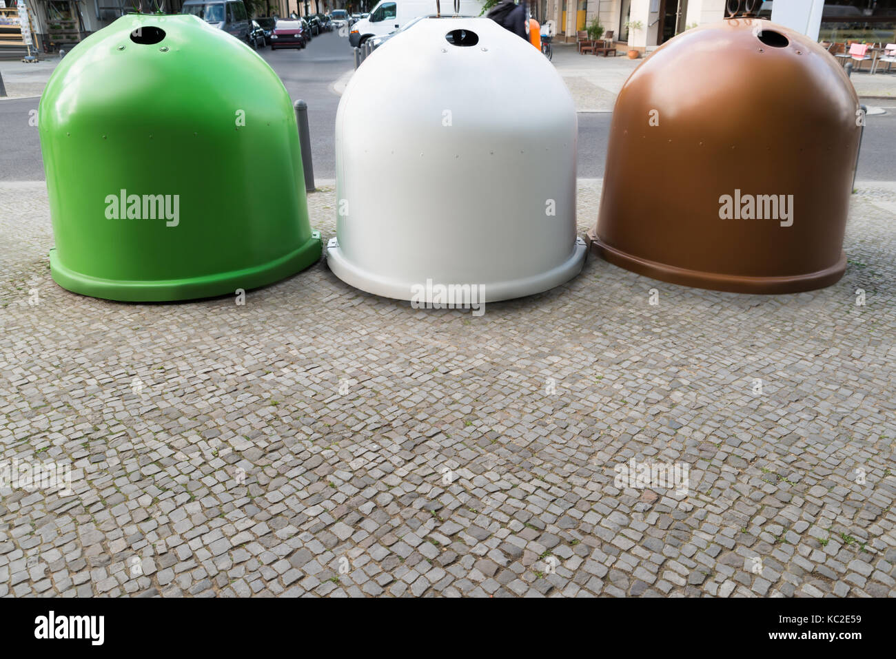 Three Colorful Glass Recycling Bins Containers On Sidewalk Stock Photo