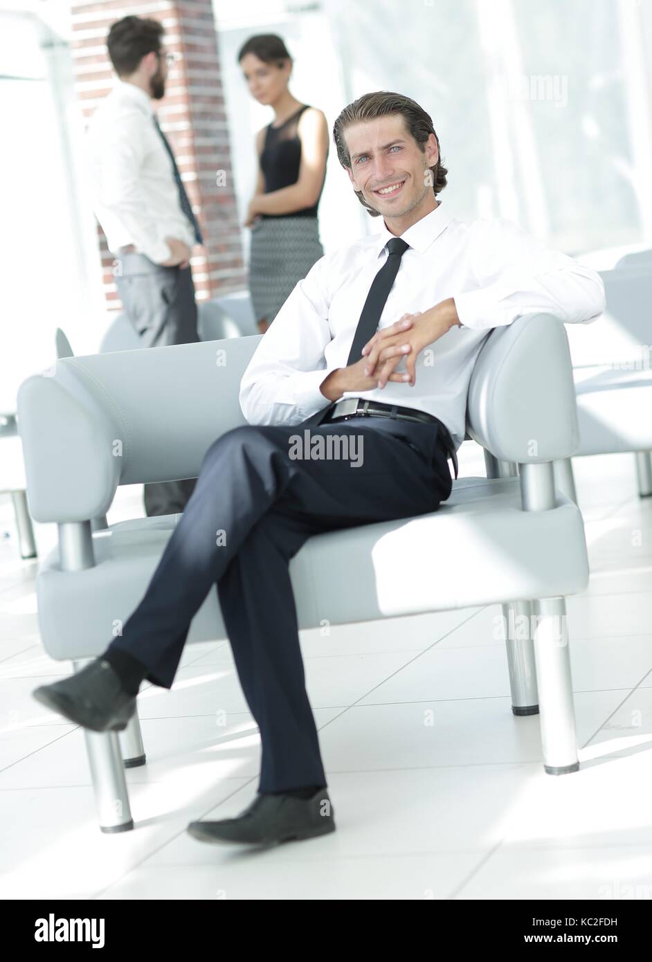 smiling businessman sitting in office chair Stock Photo - Alamy