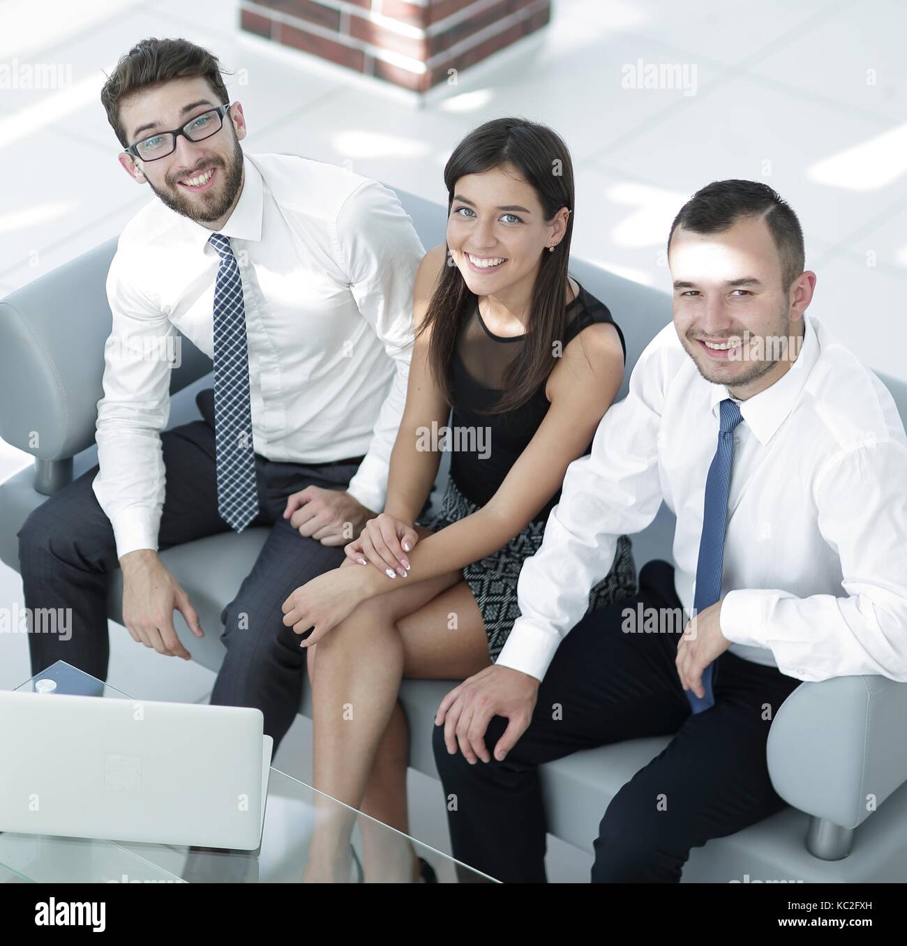 friendly business team sitting in office lobby Stock Photo - Alamy