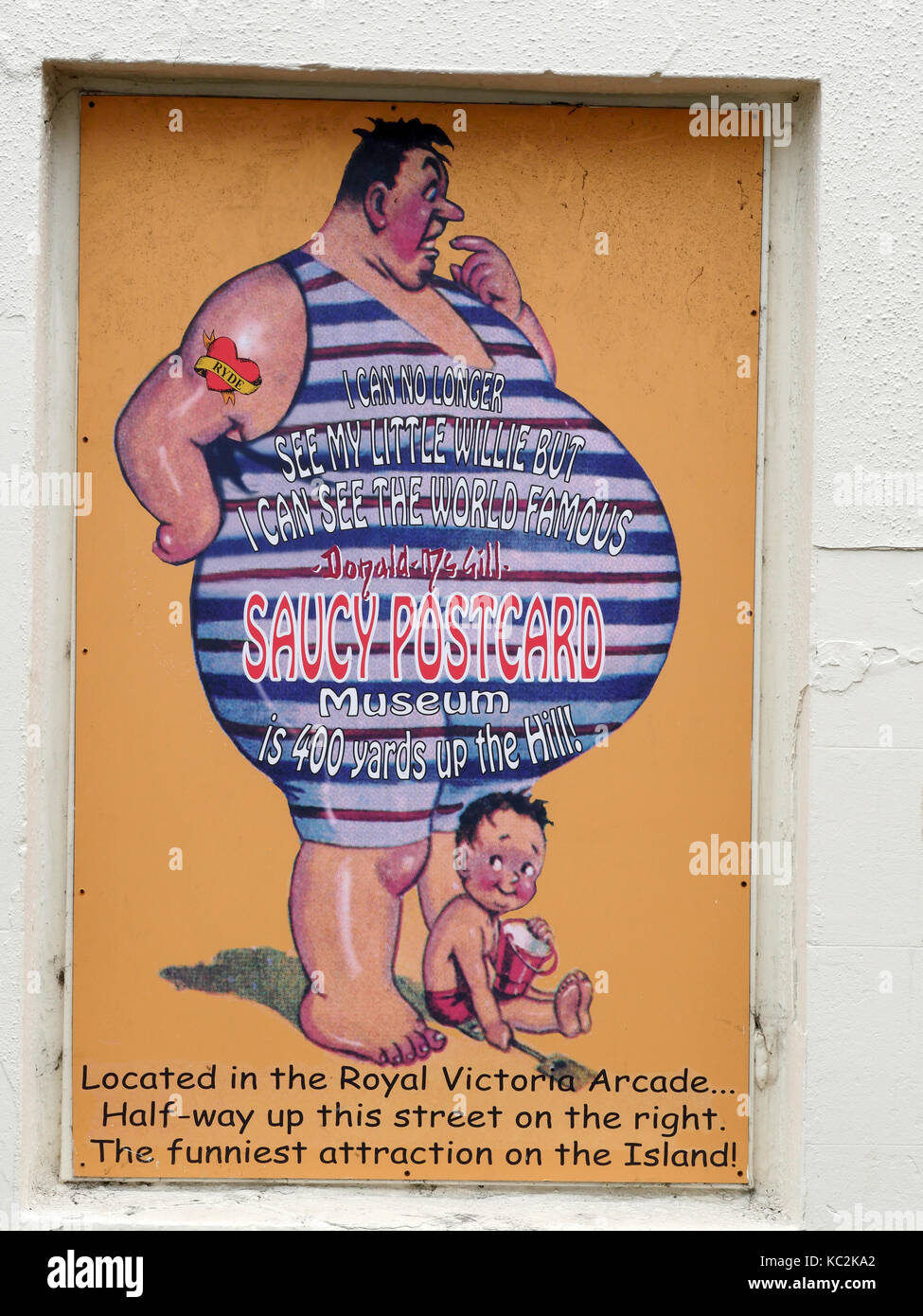 Street sign depicting a saucy postcard and giving directions to the Saucy Postcard Museum situated in the Royal Victorian Arcade, Ryde, Isle of Wight. Stock Photo