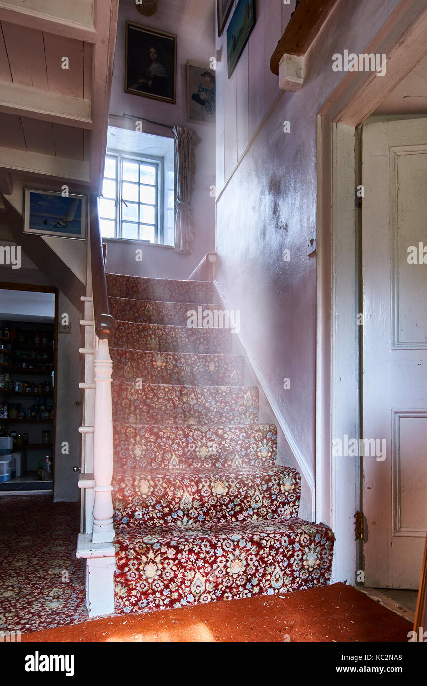 Quaint house interior; rooms with shadows and sunlit windows.  Old feel and cluttered rooms with chairs, books, CD's and house hold items. Stock Photo