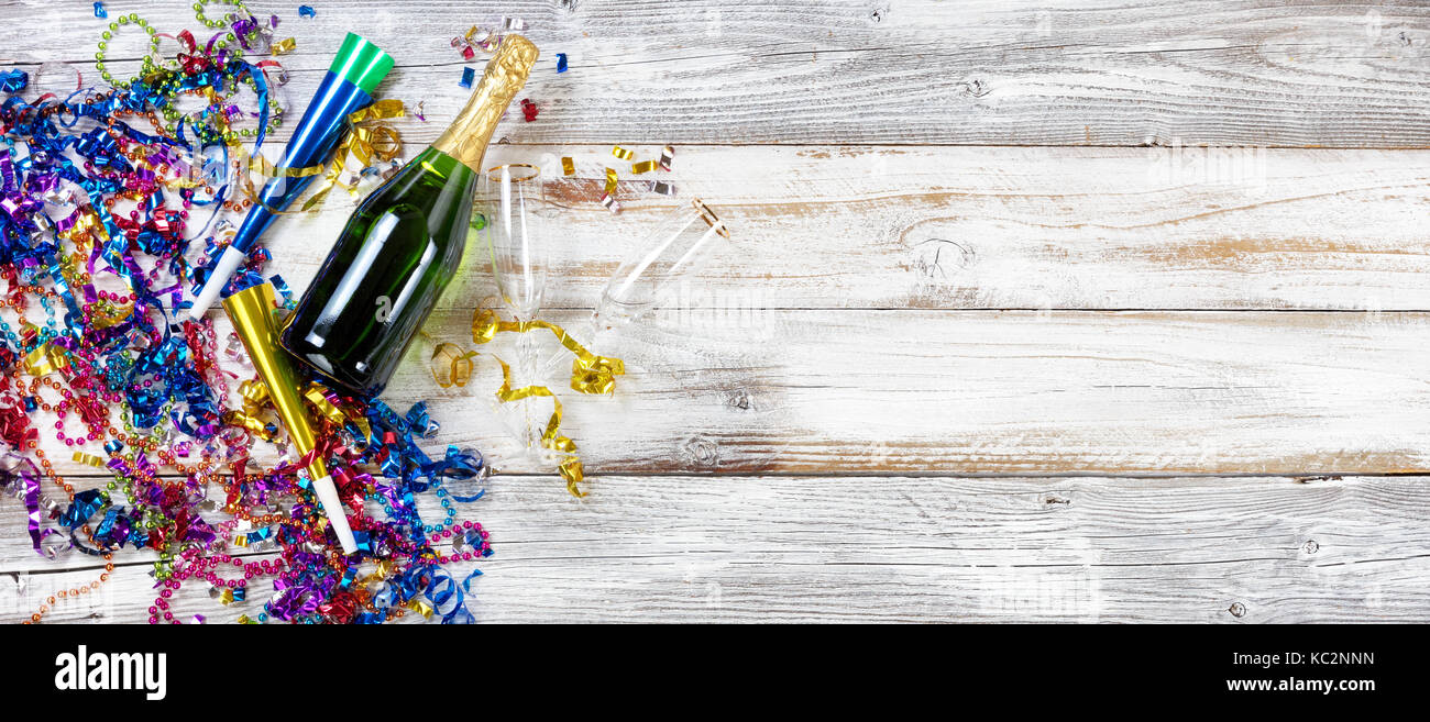 New Year eve party decorations and champagne with drinking glasses on rustic white wooden background Stock Photo