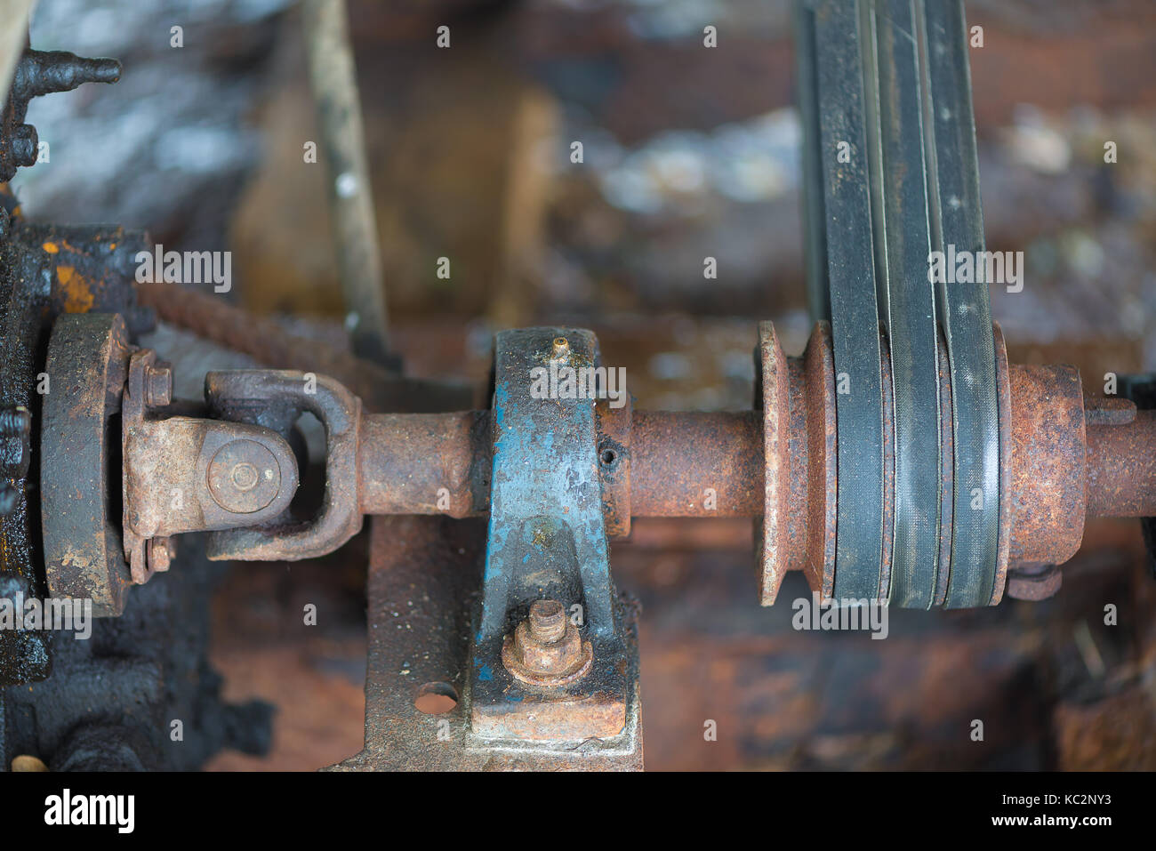 Part of the old rusty gearbox and drive shaft with grunge oil dirty