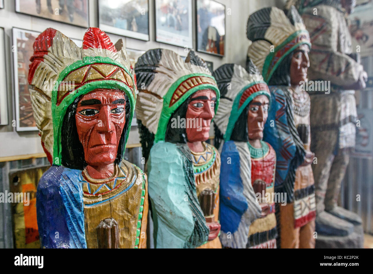 Wooden statues of Indians are displayed in a Wild West themed store in Manhattan. Stock Photo