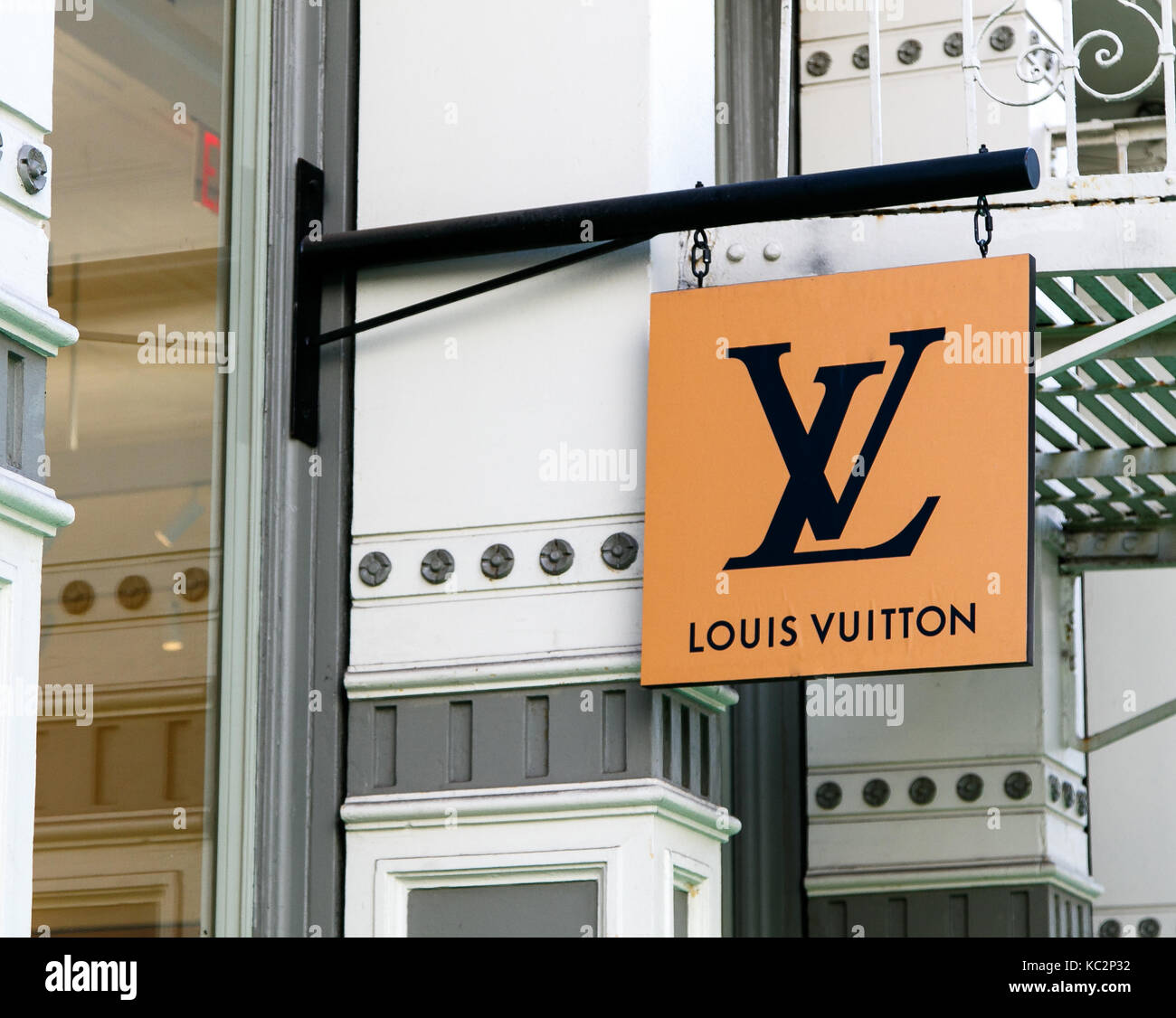 Louis Vuitton banner is suspended above the entrance to their store in SoHo. Stock Photo