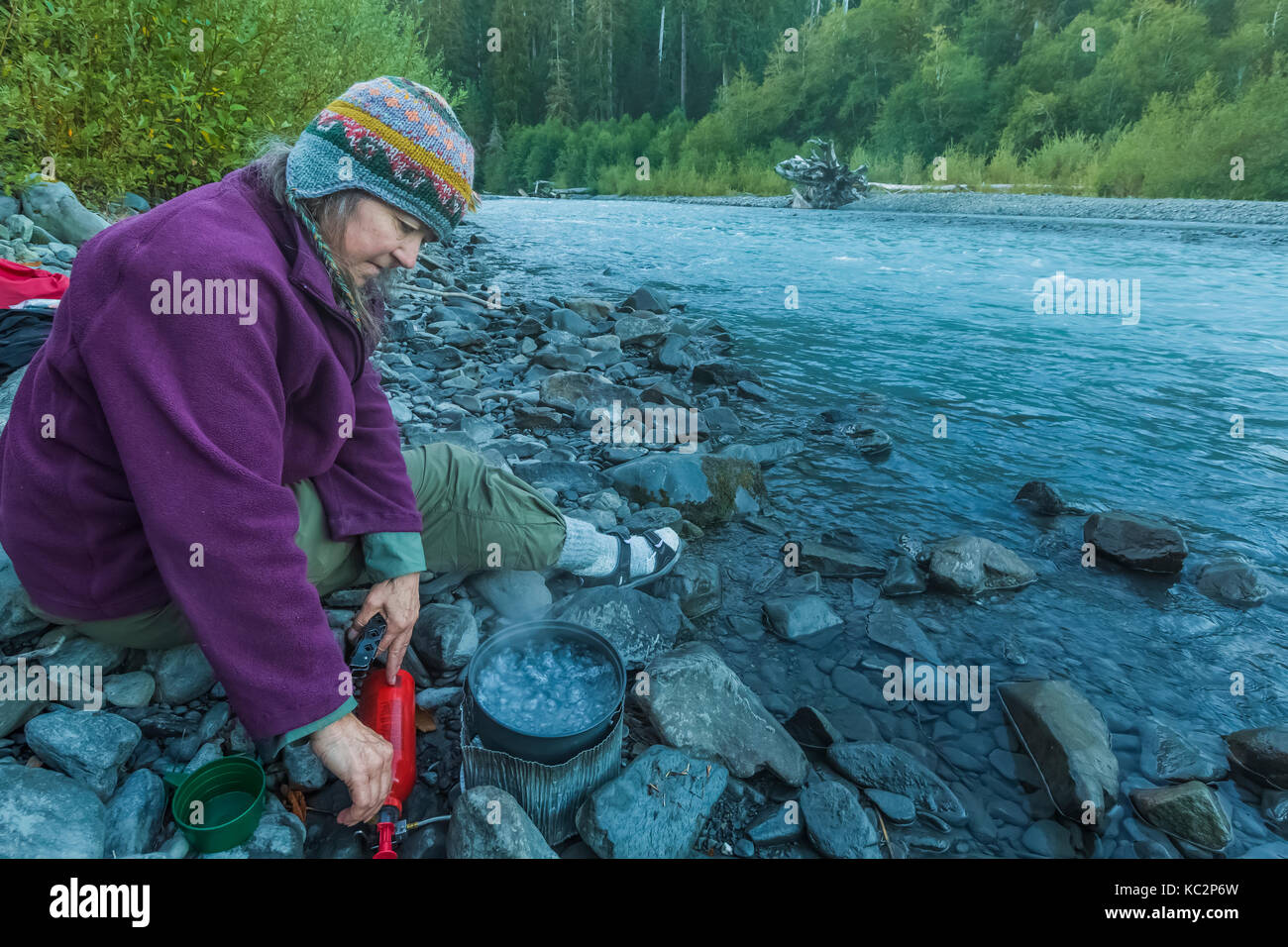 Karen Rentz boiling water for dinner at Happy Four Camp along Hoh River Trail to Blue Glacier, Olympic National Park, Washington State, USA Stock Photo