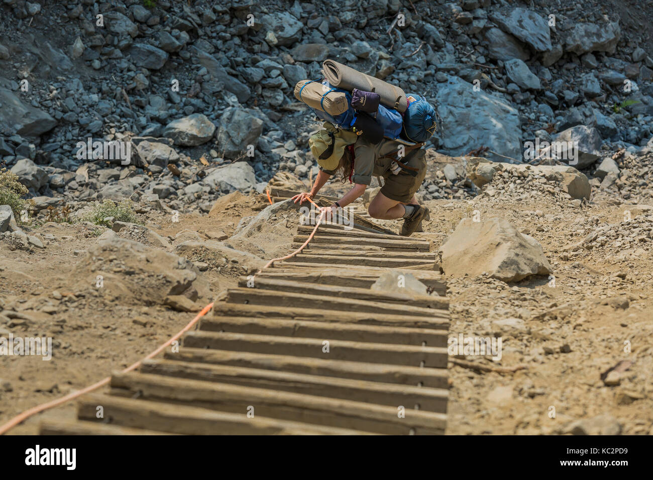 Descending Rope Ladder Backpacker Karen Rentz descending a long, steep rope ladder along the ...
