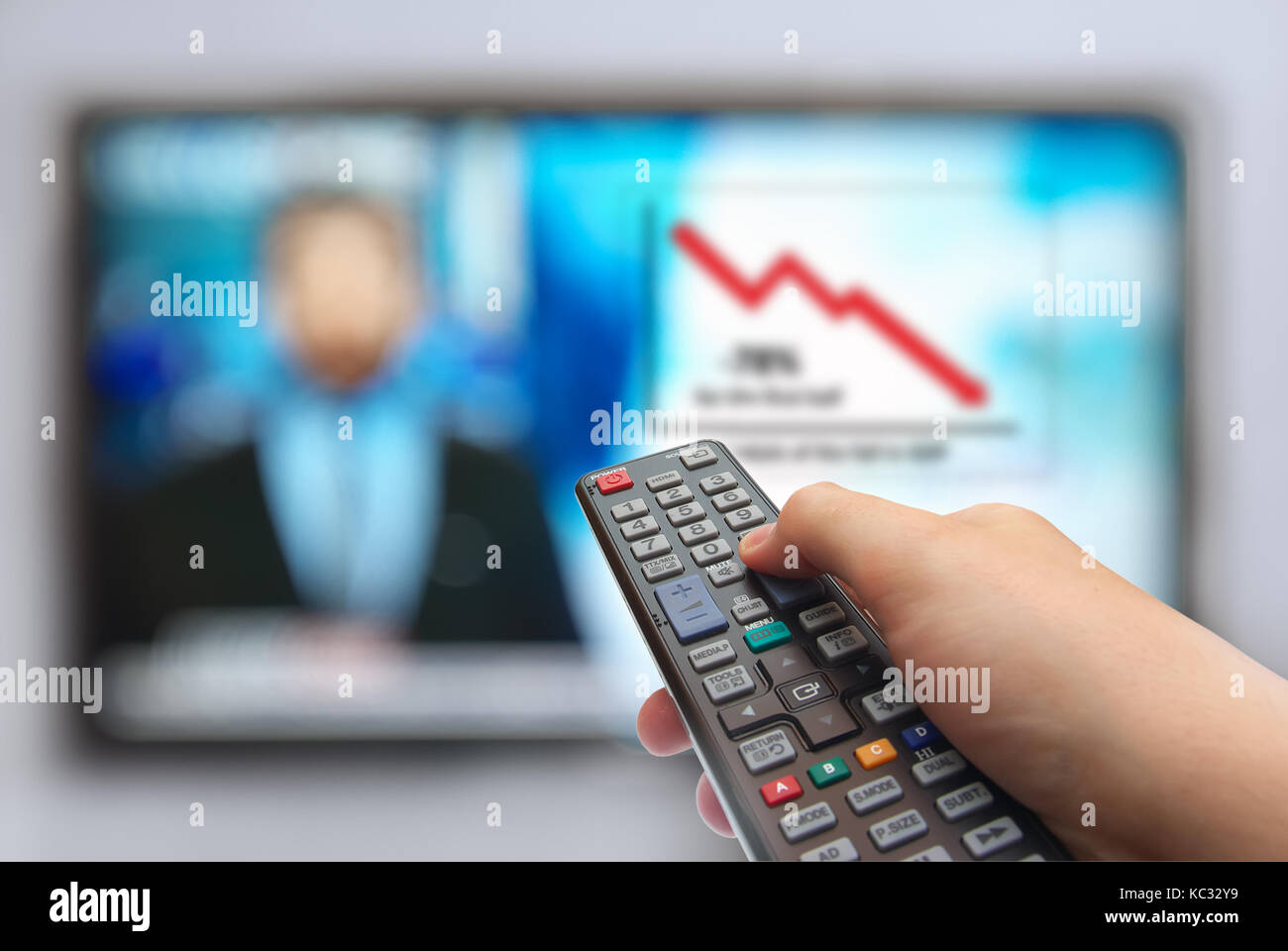 Man hand switches TV channels. Remote control in hand and TV. News in prime-time Stock Photo
