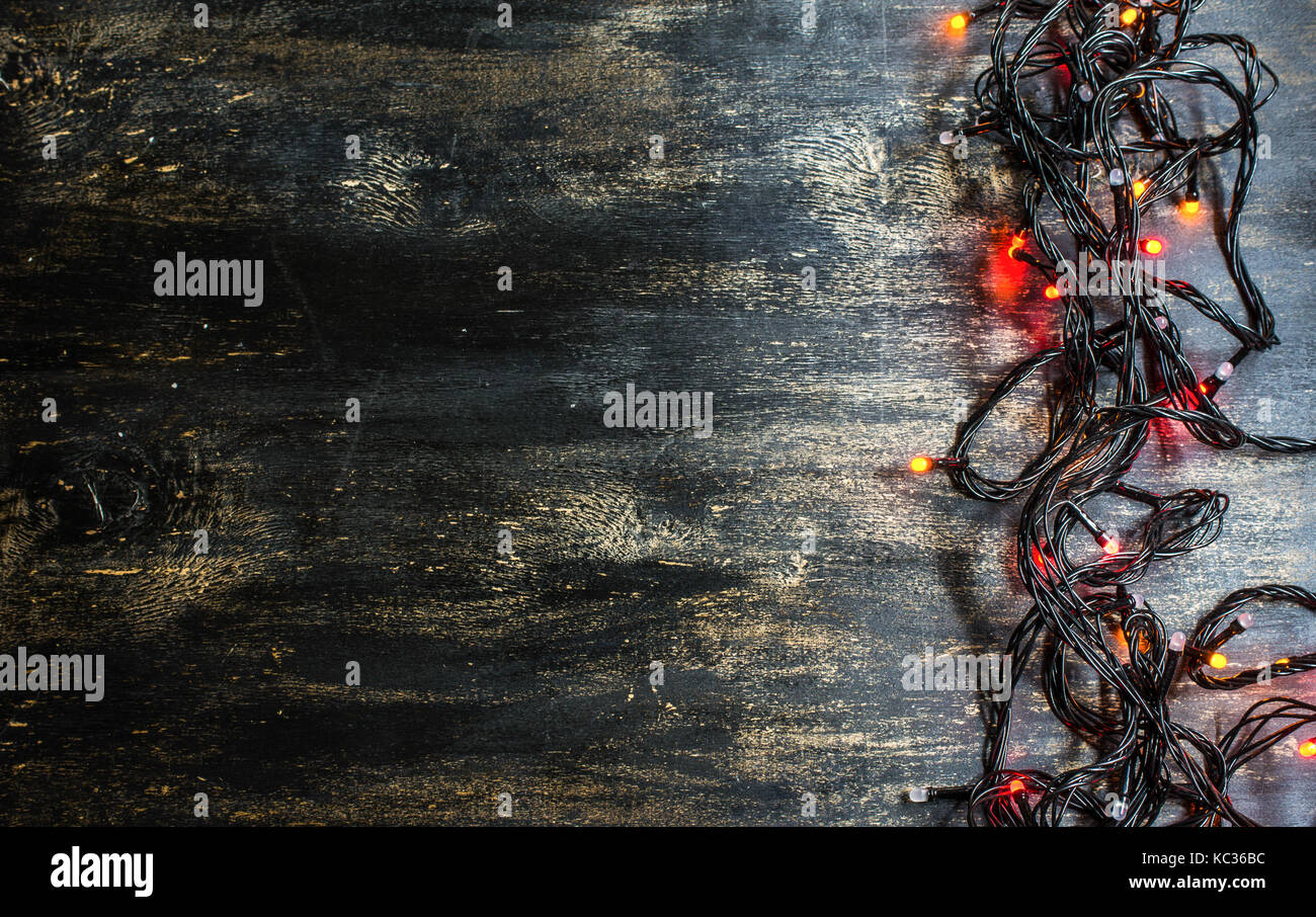 Christmas lights on dark rustic background Stock Photo - Alamy