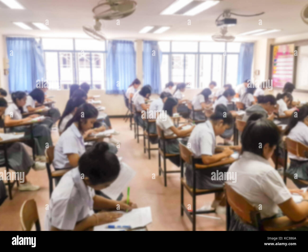 Blur school or university students writing answer doing exam in ...