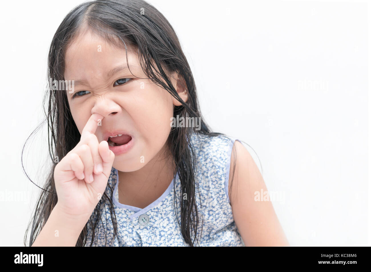 Little cute girl pick her nose on white background, Health care and hygiene concept Stock Photo