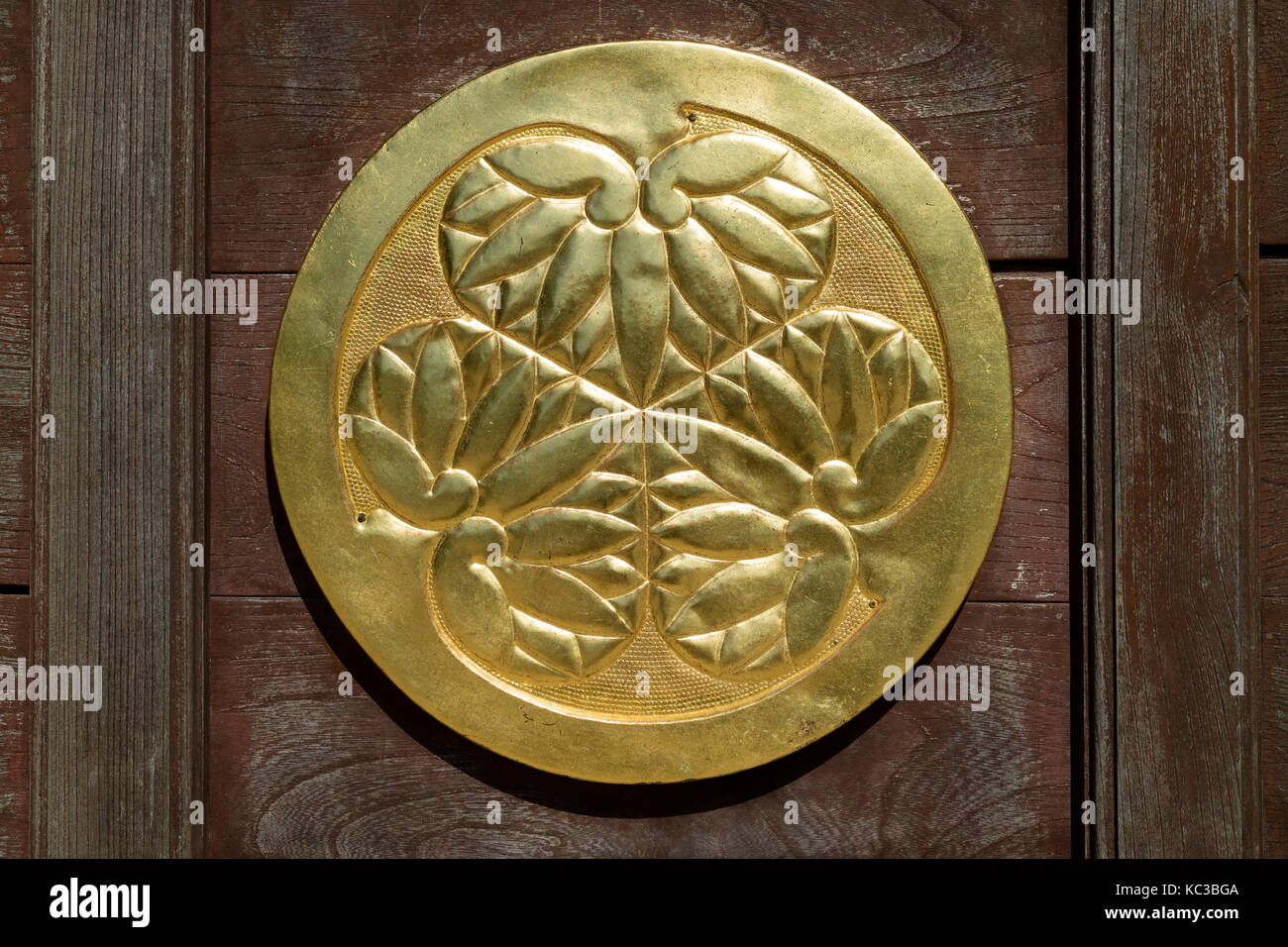 Kyoto, Japan - May 18, 2017:  Gold plated ornament with lotus flowers on a wooden doorl in Chion-In Temple Kyoto, Japan Stock Photo