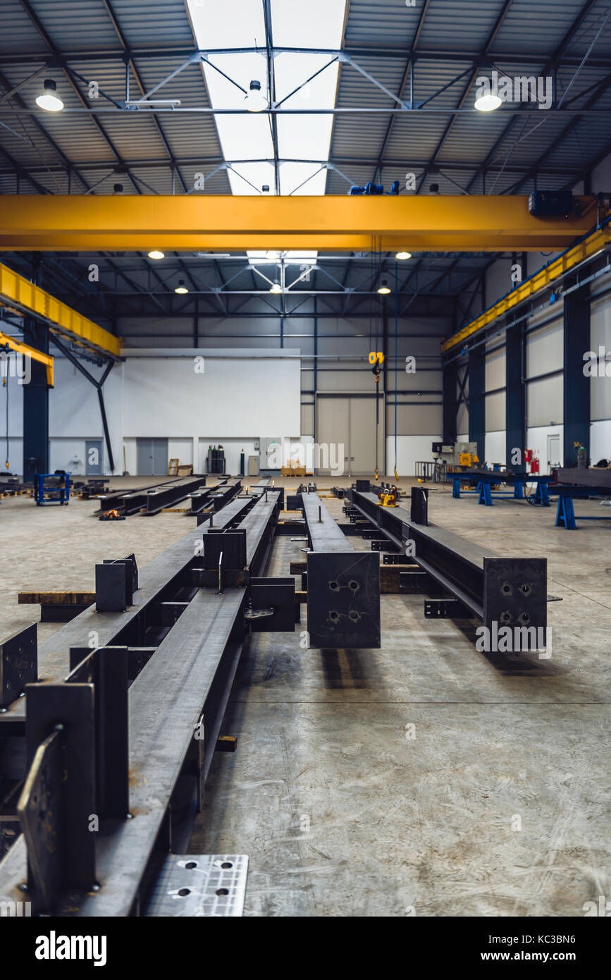 Industrial hall with cutting, welding machines and metal profiles with