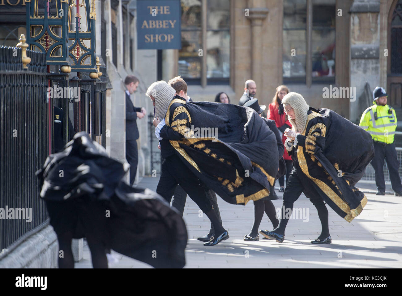 Members of the judiciary hold onto their gowns in the wind as they walk to Westminster Abbey, London, for the annual Judges Service. Stock Photo