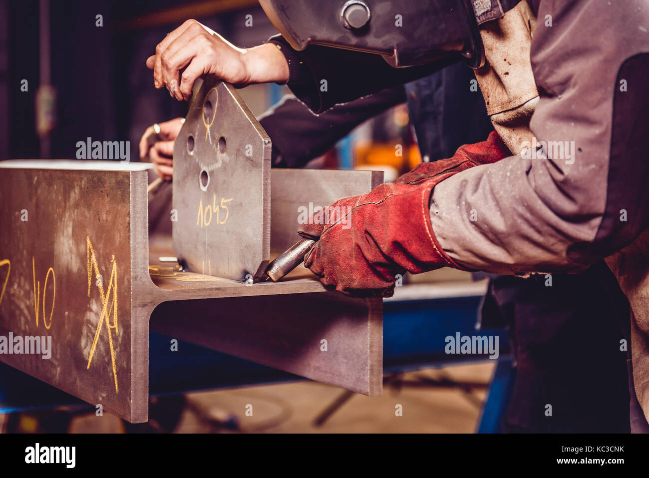 Industrial Welder With Torch preparing to welding metal profiles Stock Photo